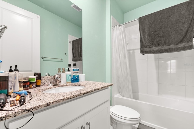 full bathroom with shower / bath combo, vanity, and toilet