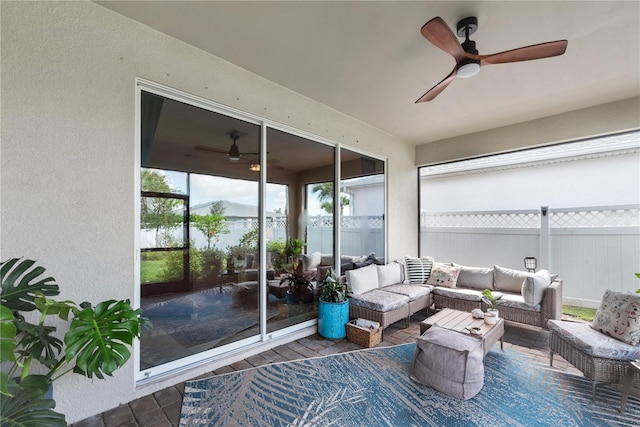 sunroom featuring ceiling fan