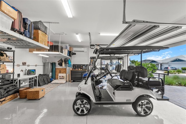 garage featuring water heater and an AC wall unit