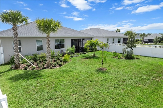 back of property featuring a lawn