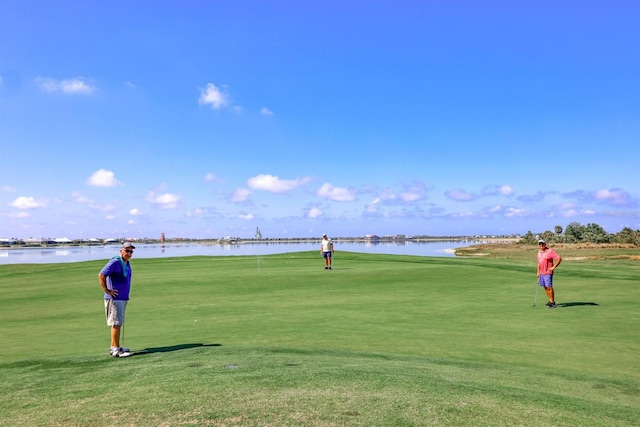 surrounding community featuring a water view and a yard