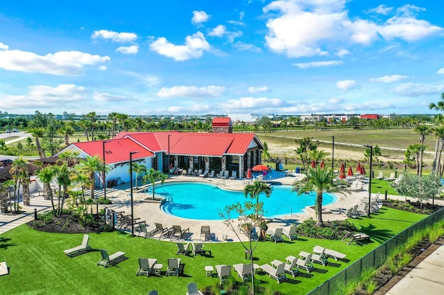 view of swimming pool featuring a patio area and a yard