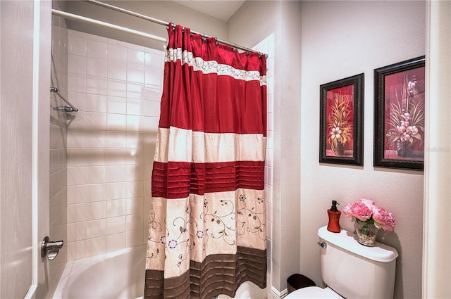 bathroom with toilet and shower / bath combo with shower curtain