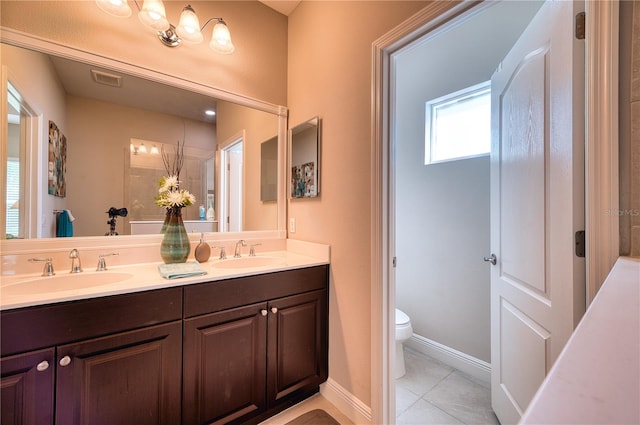 bathroom featuring vanity, toilet, and tile patterned floors