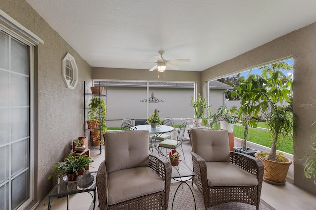 sunroom with ceiling fan