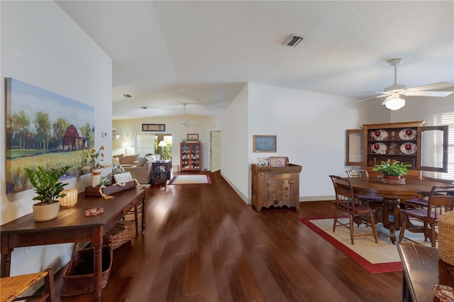 dining space featuring ceiling fan, dark hardwood / wood-style flooring, and lofted ceiling