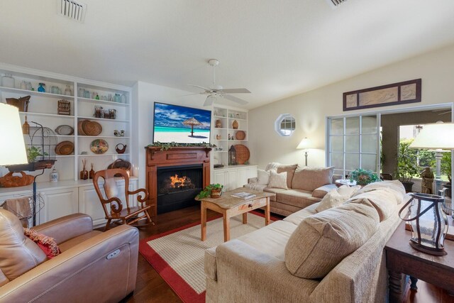 living room with ceiling fan and dark hardwood / wood-style flooring