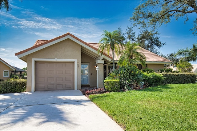 view of front of property featuring a garage and a front lawn