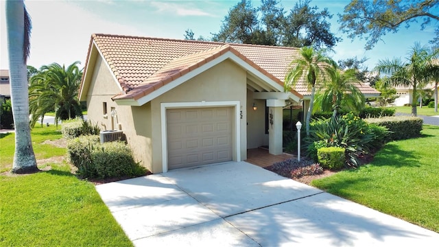 view of front of home featuring a front yard and a garage