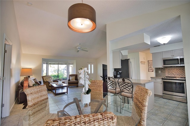 interior space featuring ceiling fan and vaulted ceiling