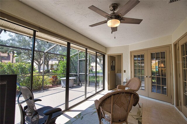 sunroom / solarium with ceiling fan, french doors, and a wealth of natural light