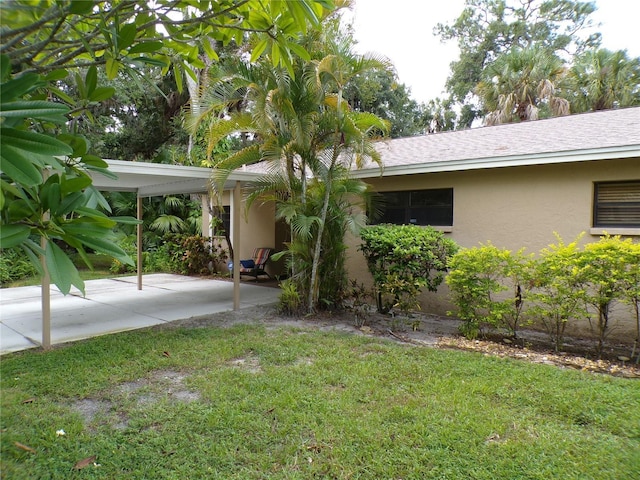 4973 Village Gardens Dr Unit 50, Sarasota, FL 34234 - view of green lawn with an attached carport