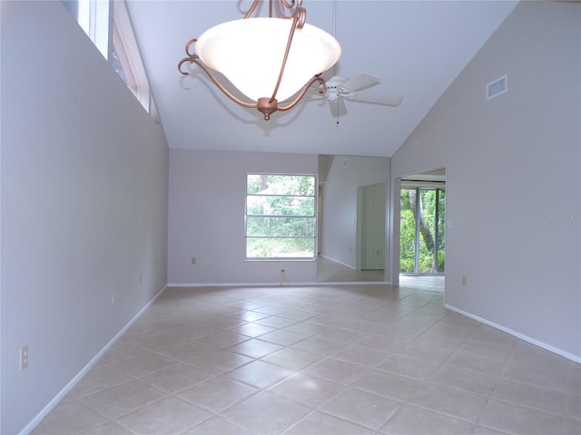 4973 Village Gardens Dr Unit 50, Sarasota, FL 34234 - empty room with high vaulted ceiling, light tile patterned floors, and ceiling fan