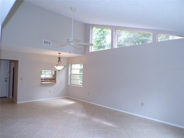 4973 Village Gardens Dr Unit 50, Sarasota, FL 34234 - spare room featuring ceiling fan, light tile patterned flooring, and high vaulted ceiling
