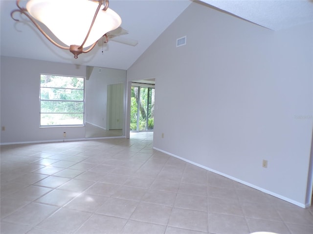 4973 Village Gardens Dr Unit 50, Sarasota, FL 34234 - spare room with light tile patterned floors and high vaulted ceiling