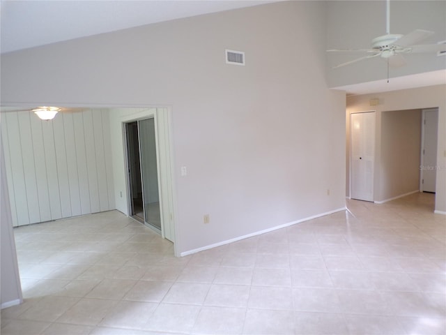 4973 Village Gardens Dr Unit 50, Sarasota, FL 34234 - spare room with ceiling fan, high vaulted ceiling, and light tile patterned floors