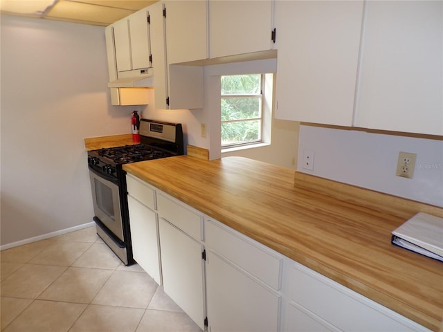 4973 Village Gardens Dr Unit 50, Sarasota, FL 34234 - kitchen with stainless steel gas stove, under cabinet range hood, light countertops, and white cabinetry