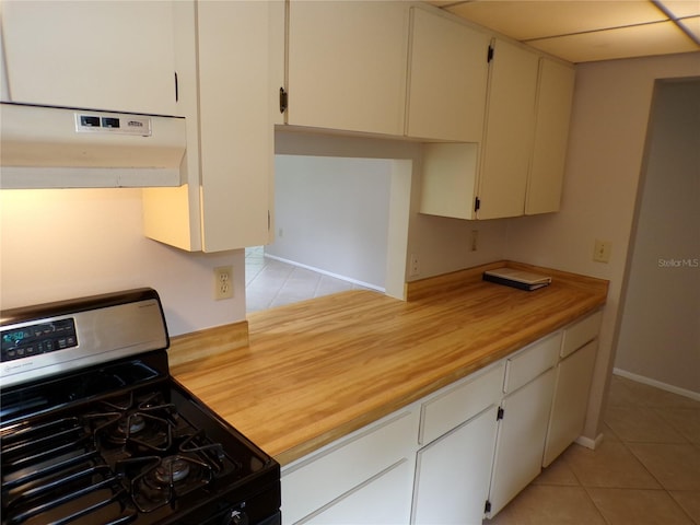 4973 Village Gardens Dr Unit 50, Sarasota, FL 34234 - kitchen featuring stainless steel gas stove, under cabinet range hood, light tile patterned flooring, and butcher block countertops