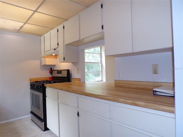 4973 Village Gardens Dr Unit 50, Sarasota, FL 34234 - kitchen featuring gas range, under cabinet range hood, white cabinets, light countertops, and light tile patterned flooring