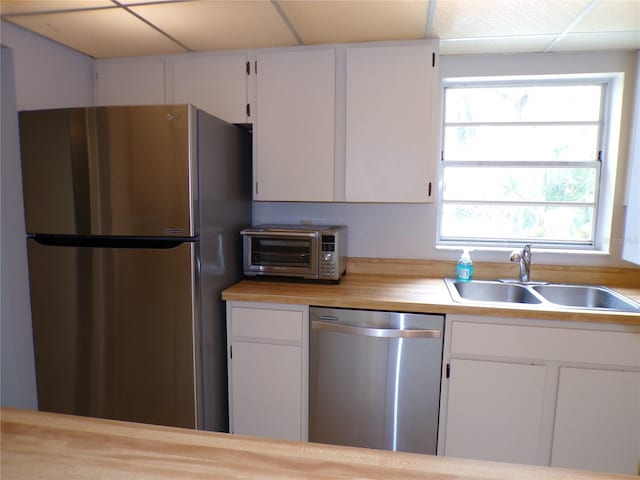 4973 Village Gardens Dr Unit 50, Sarasota, FL 34234 - kitchen with appliances with stainless steel finishes and white cabinetry