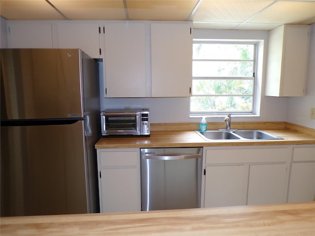 4973 Village Gardens Dr Unit 50, Sarasota, FL 34234 - kitchen featuring stainless steel appliances, white cabinets, and wooden counters
