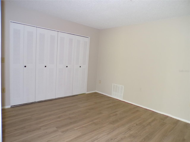 4973 Village Gardens Dr Unit 50, Sarasota, FL 34234 - unfurnished bedroom with light wood-type flooring and a closet