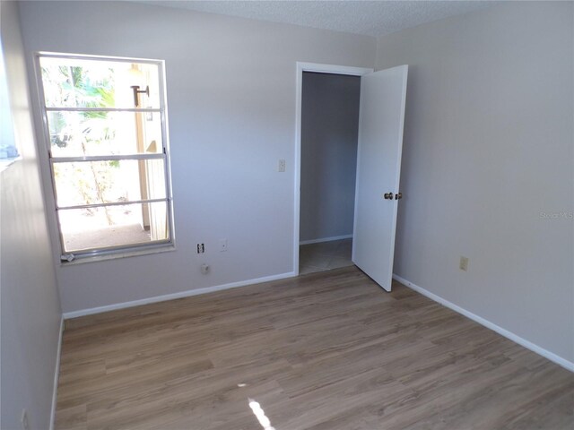 4973 Village Gardens Dr Unit 50, Sarasota, FL 34234 - unfurnished room with wood finished floors and baseboards