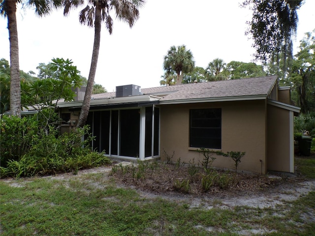 4973 Village Gardens Dr Unit 50, Sarasota, FL 34234 - rear view of property featuring stucco siding, a sunroom, and a shingled roof