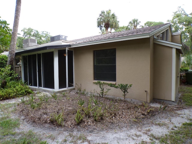 4973 Village Gardens Dr Unit 50, Sarasota, FL 34234 - rear view of house with a sunroom and stucco siding