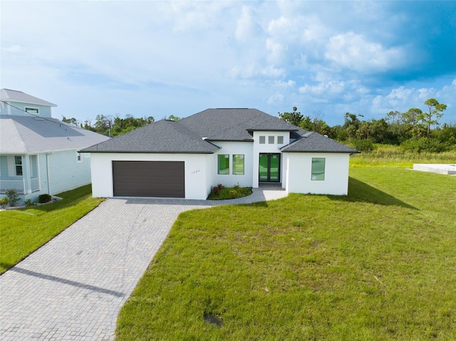 view of front of property with a garage and a front lawn