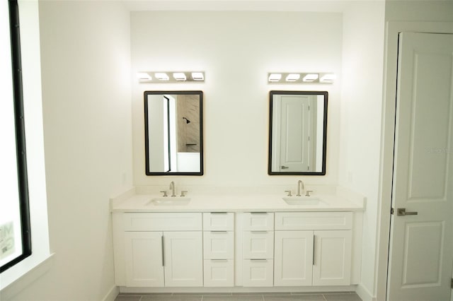 bathroom with tile patterned flooring and vanity