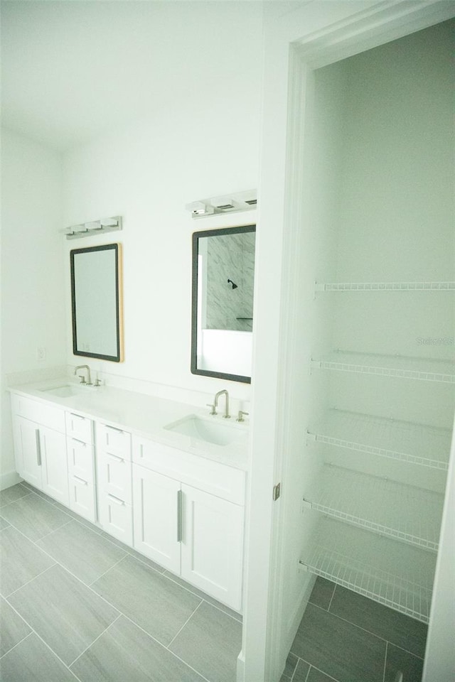 bathroom featuring tile patterned flooring and vanity