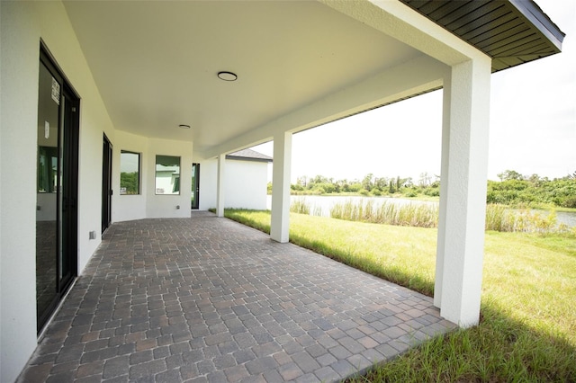 view of patio featuring a water view