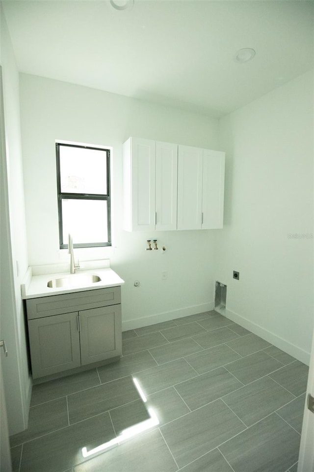 interior space featuring washer hookup, cabinets, sink, and electric dryer hookup