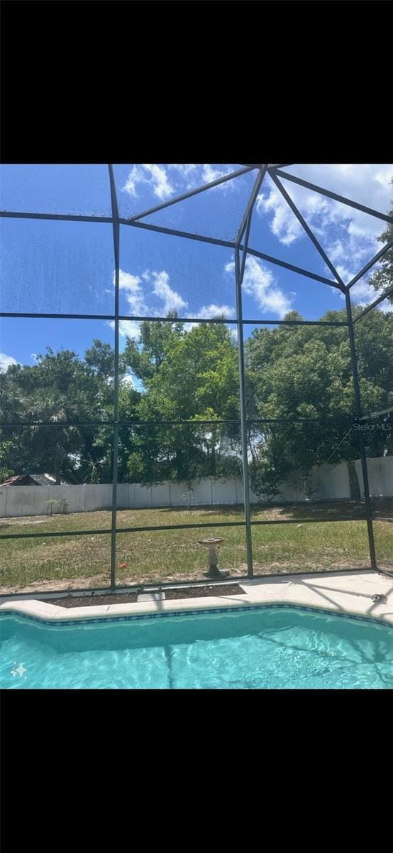 pool featuring a lanai and fence