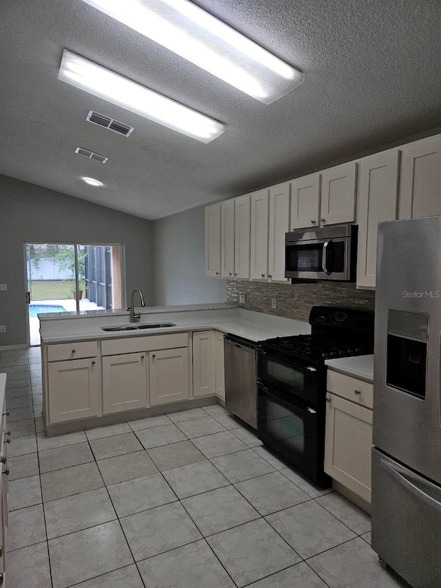 kitchen featuring white cabinets, stainless steel appliances, and light countertops