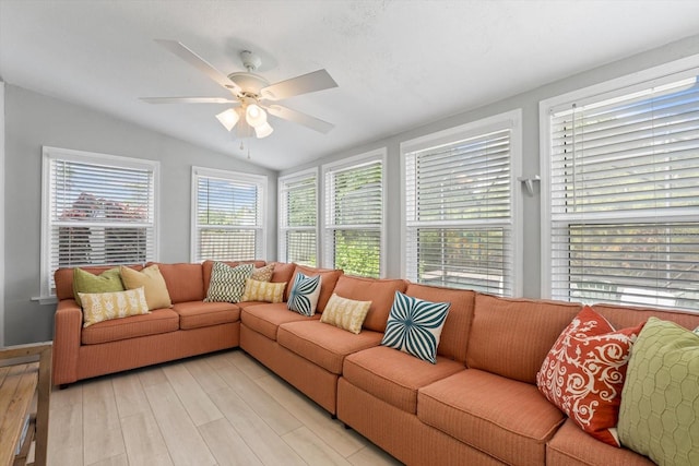 living room with lofted ceiling, light wood-type flooring, and ceiling fan