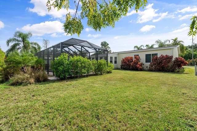 view of yard featuring glass enclosure