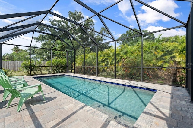 view of swimming pool with a patio and a lanai