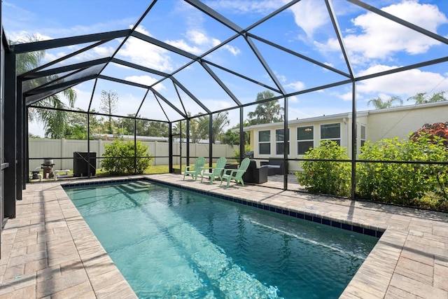 view of pool with a patio area and a lanai