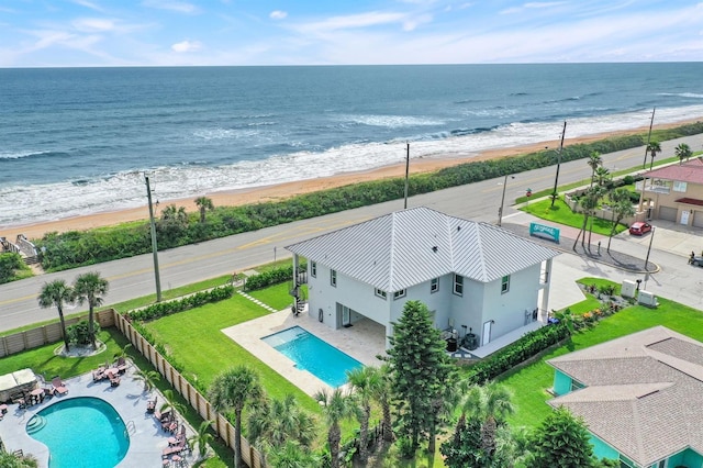 drone / aerial view featuring a view of the beach and a water view