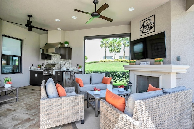 living room with ceiling fan and a fireplace