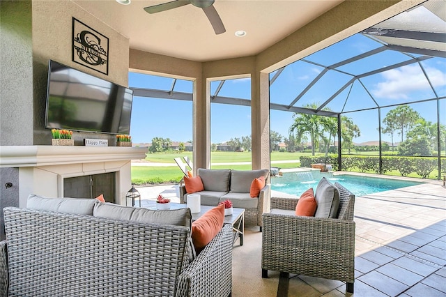 view of patio featuring outdoor lounge area, pool water feature, ceiling fan, and a lanai