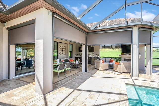 view of patio with outdoor lounge area and a lanai