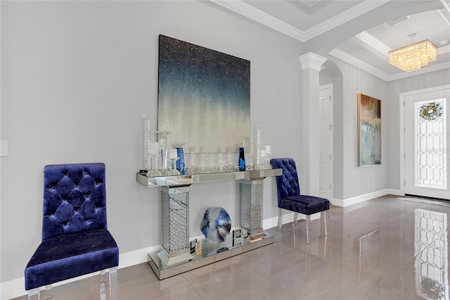 tiled entryway with ornamental molding, a notable chandelier, and decorative columns