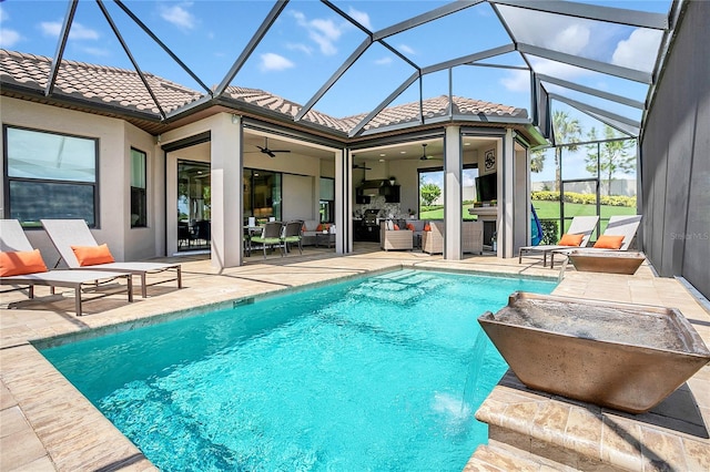 view of swimming pool with ceiling fan, a lanai, a patio, and an outdoor living space