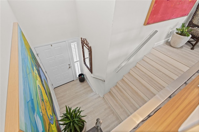 staircase featuring wood-type flooring