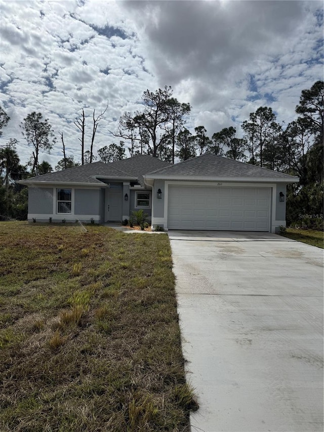 single story home with a garage, driveway, a front yard, and stucco siding