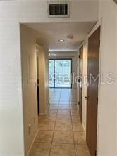 hall with light tile patterned flooring