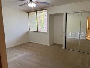 unfurnished bedroom with light colored carpet and ceiling fan